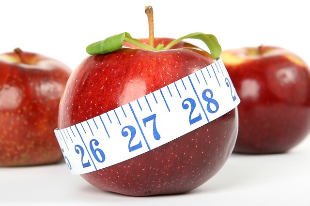 apples with tape measure wrapped around one